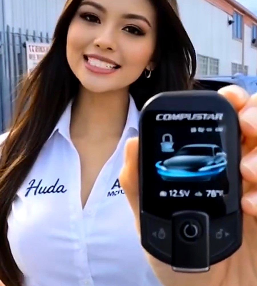 Los Angeles Car Alarm team member with a Compustar remote start controller